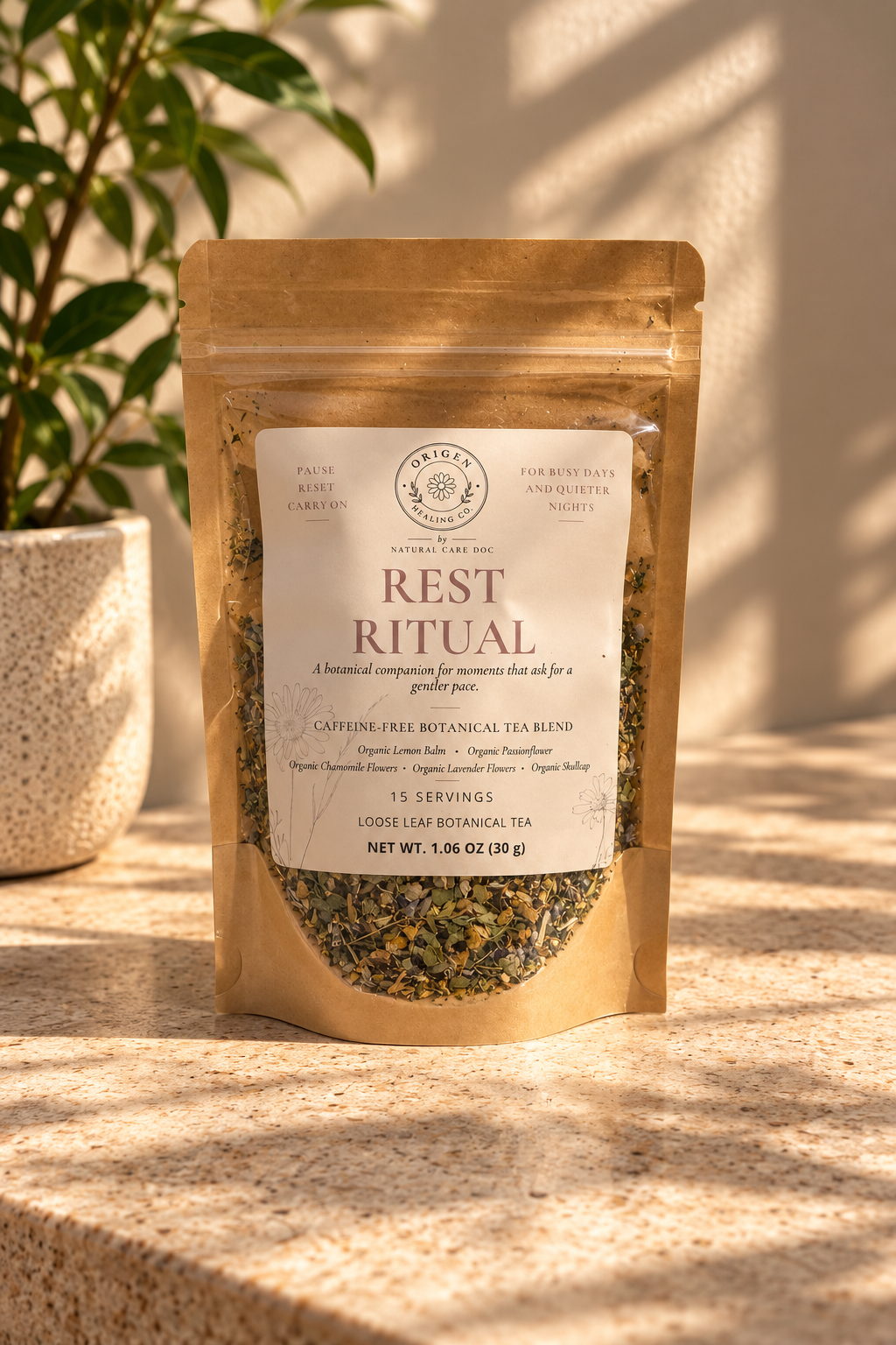 Rest Ritual kraft pouch on a sunlit stone surface beside a potted plant